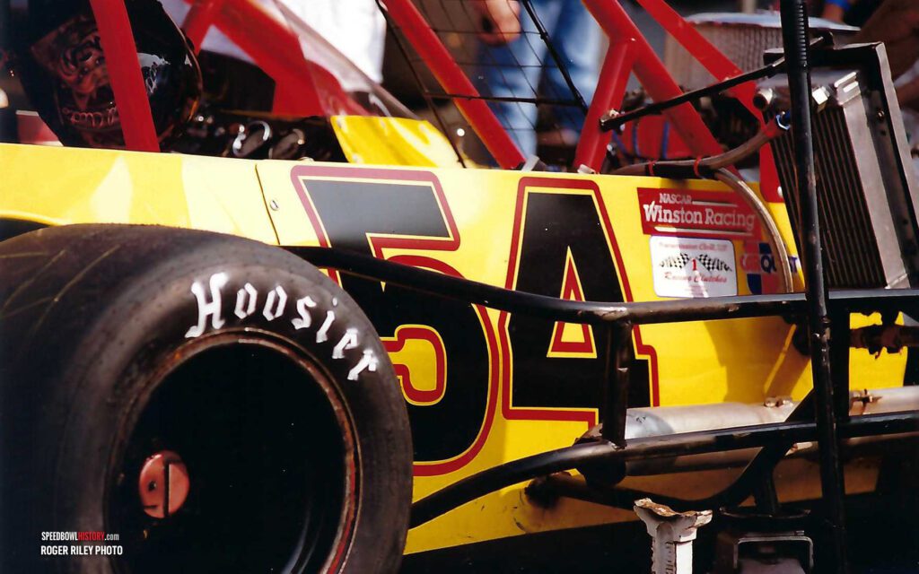 Black and white abstract pattern with concentric circles and wave shapes.