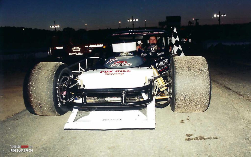 Black and white abstract pattern with concentric circles and wave shapes.