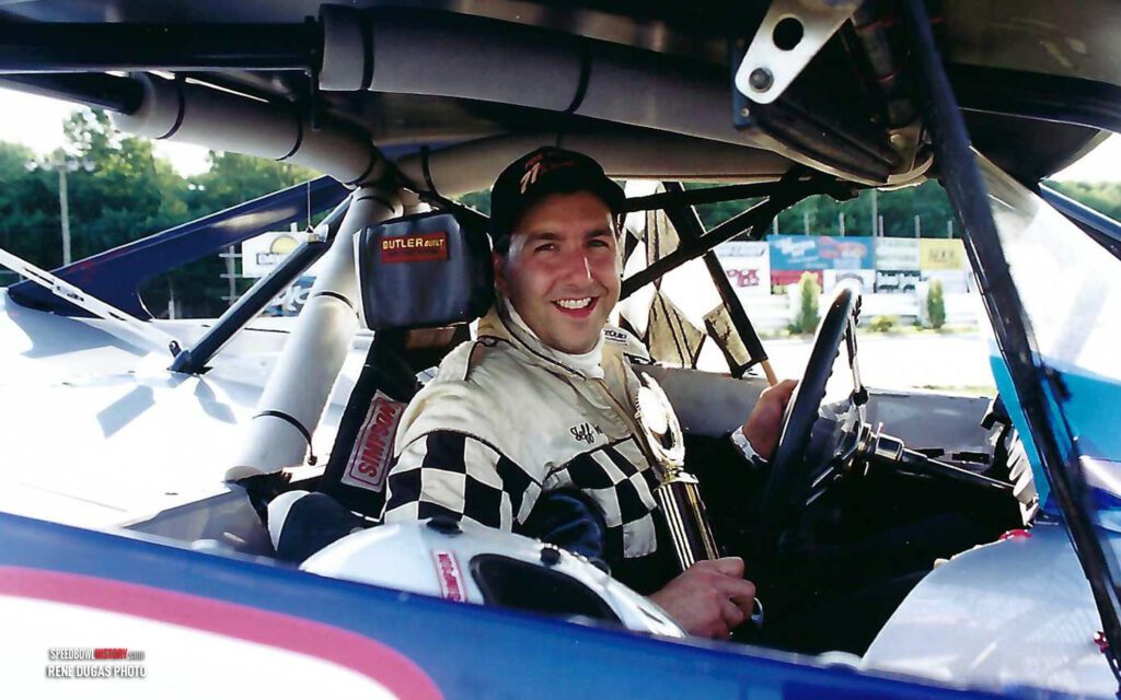 Black and white abstract pattern with concentric circles and wave shapes.