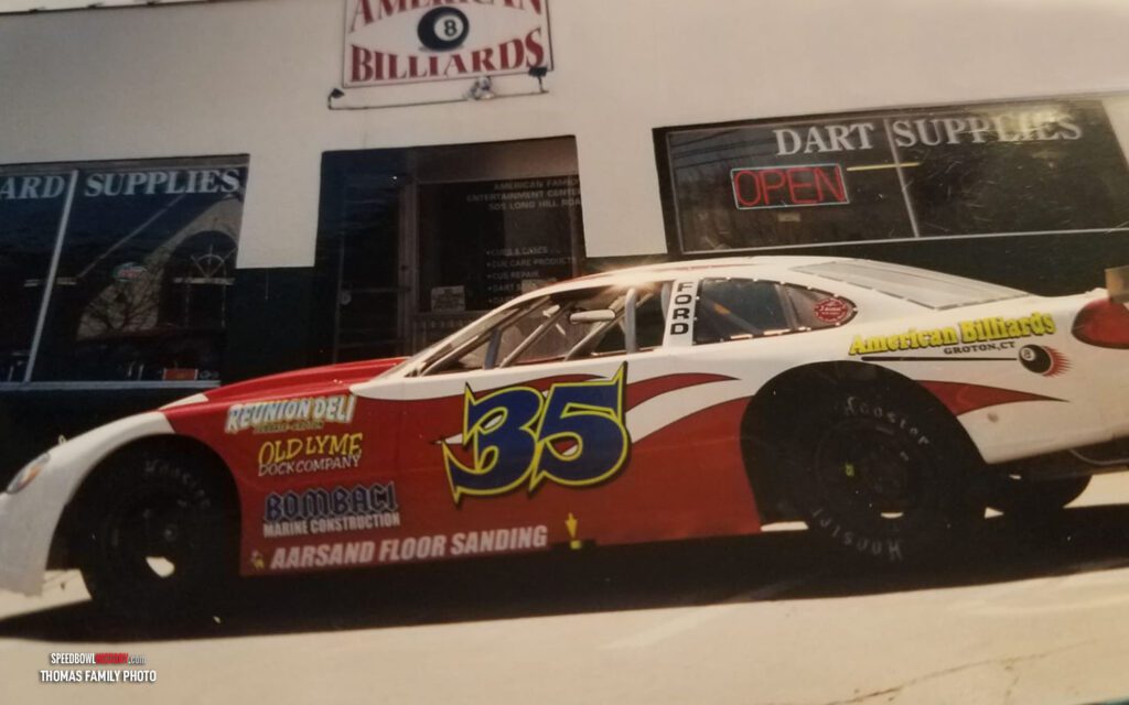 Black and white abstract pattern with concentric circles and wave shapes.