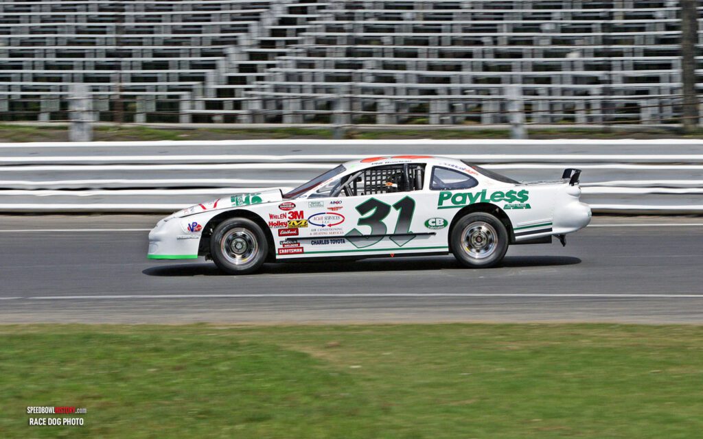 Black and white abstract pattern with concentric circles and wave shapes.