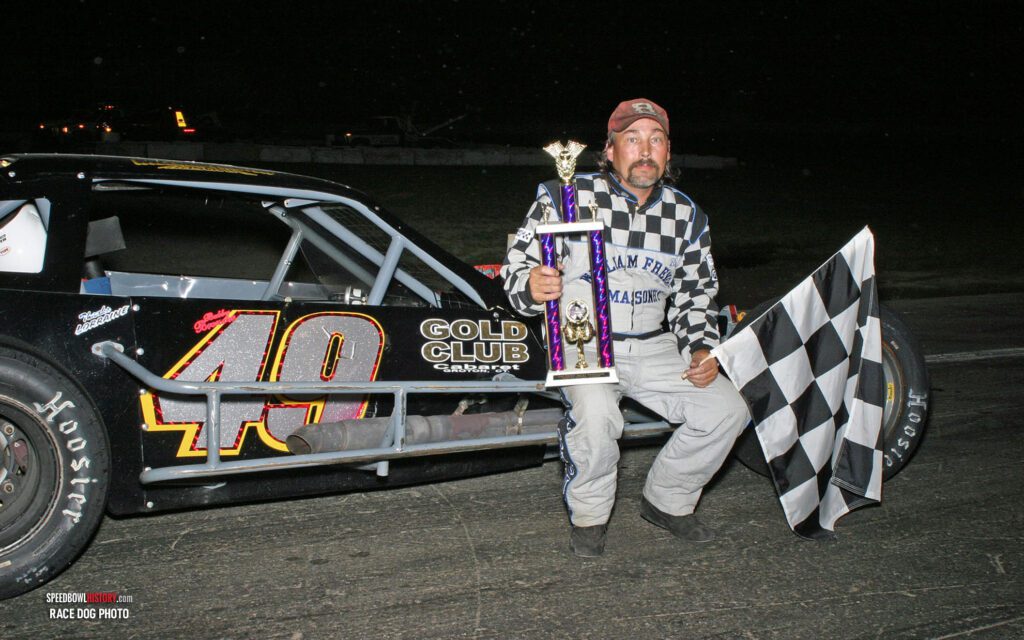 Black and white abstract pattern with concentric circles and wave shapes.