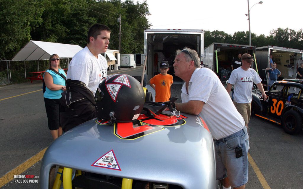 Black and white abstract pattern with concentric circles and wave shapes.