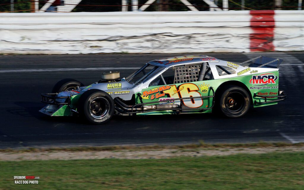 Black and white abstract pattern with concentric circles and wave shapes.