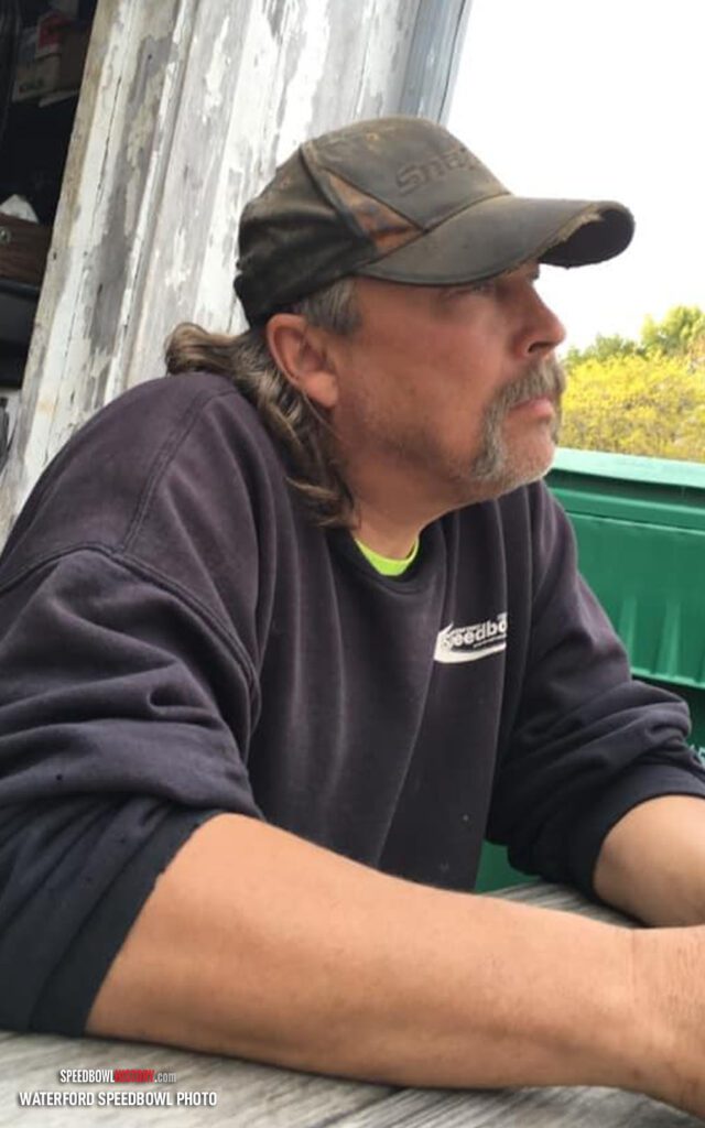 Black and white abstract pattern with concentric circles and wave shapes.