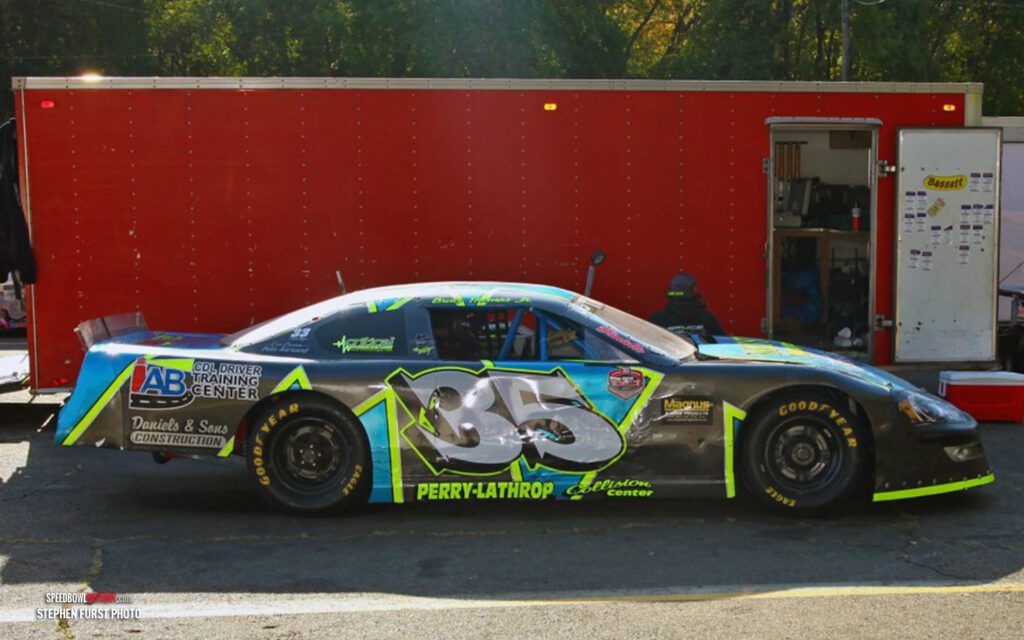 Black and white abstract pattern with concentric circles and wave shapes.