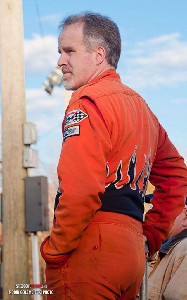 Black and white abstract pattern with concentric circles and wave shapes.