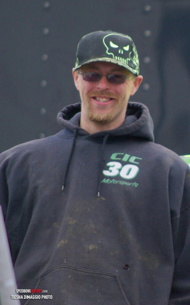 Black and white abstract pattern with concentric circles and wave shapes.