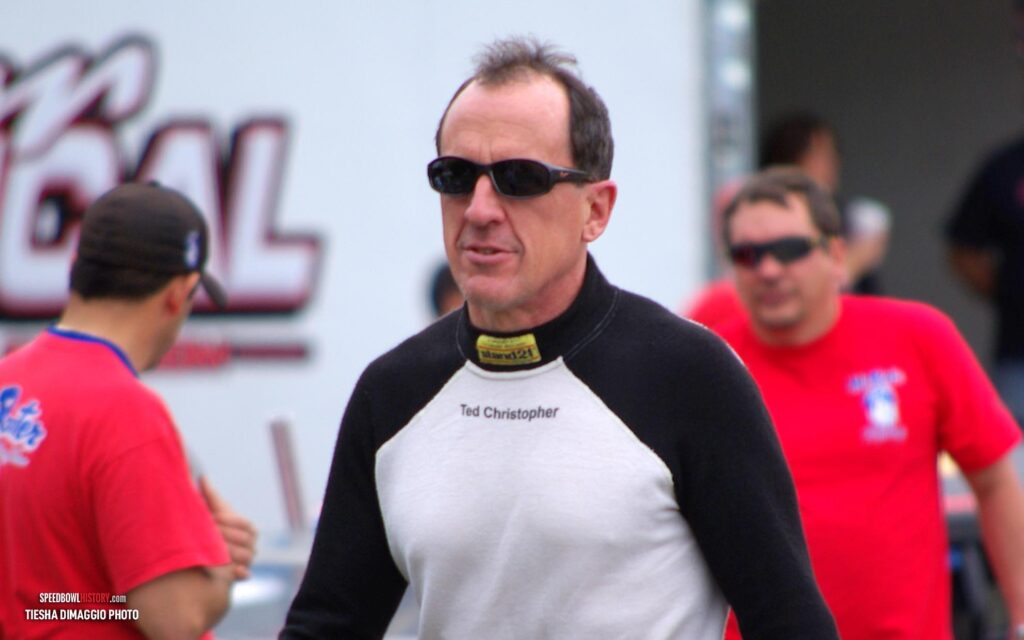 Black and white abstract pattern with concentric circles and wave shapes.