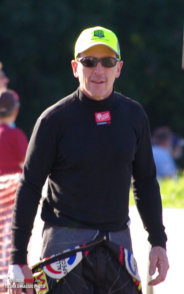 Black and white abstract pattern with concentric circles and wave shapes.