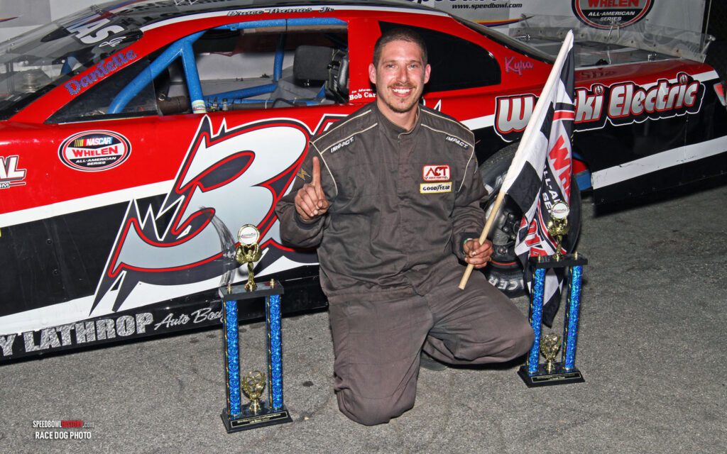 Black and white abstract pattern with concentric circles and wave shapes.