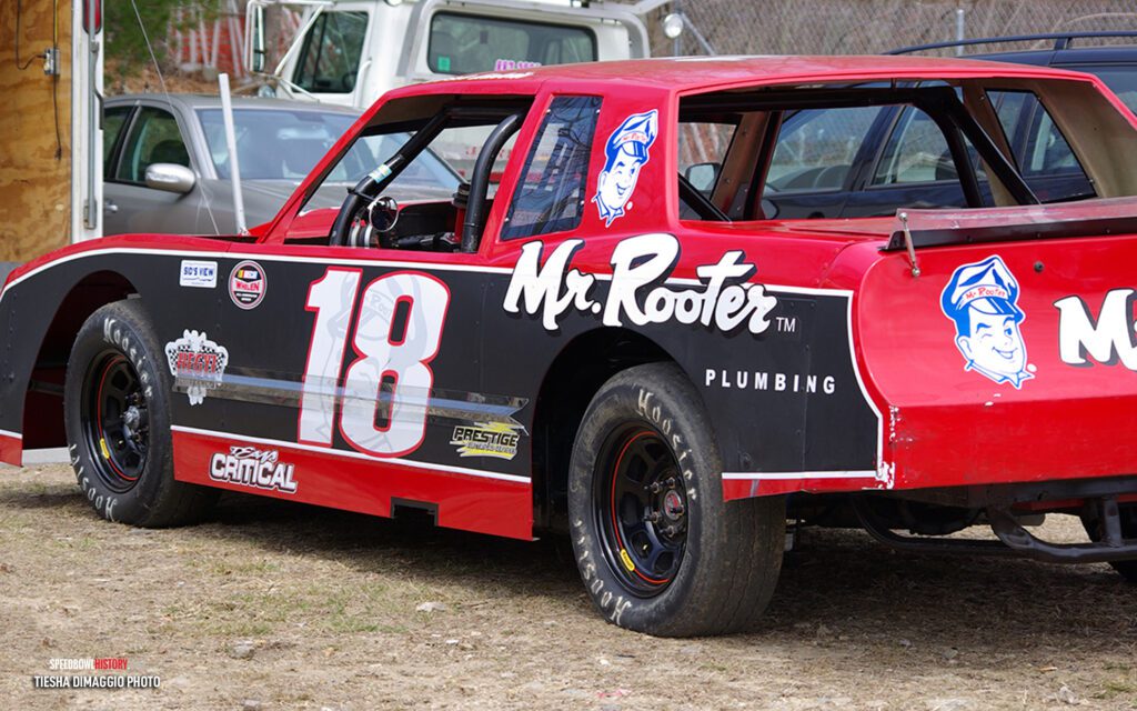 Black and white abstract pattern with concentric circles and wave shapes.