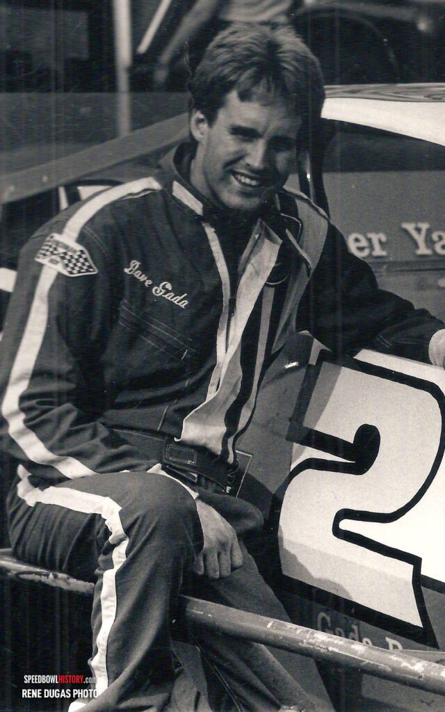 Black and white abstract pattern with concentric circles and wave shapes.