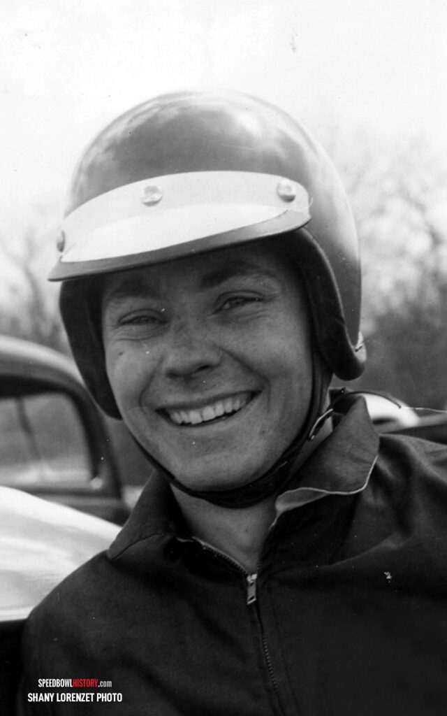 Black and white abstract pattern with concentric circles and wave shapes.