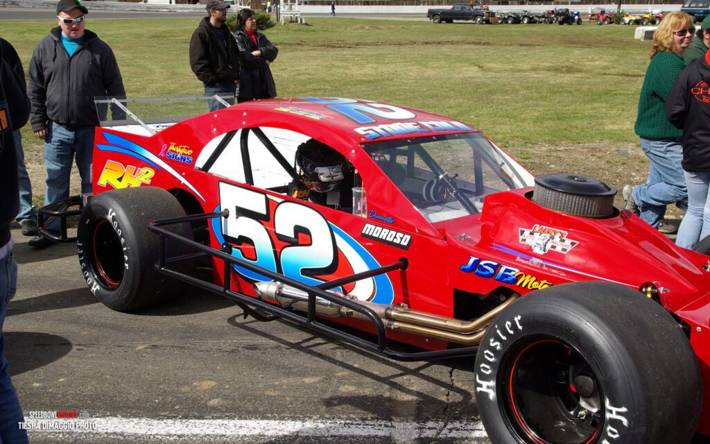 Black and white abstract pattern with concentric circles and wave shapes.