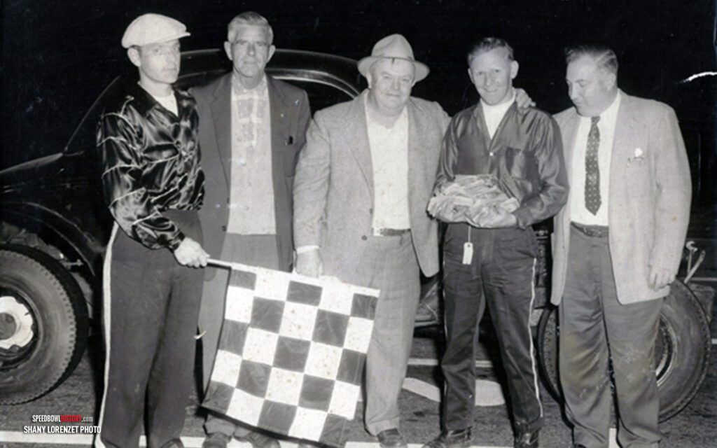 Black and white abstract pattern with concentric circles and wave shapes.