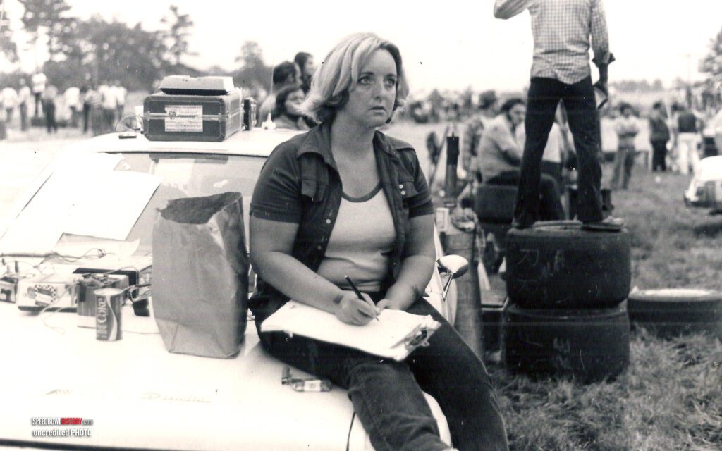 Black and white abstract pattern with concentric circles and wave shapes.