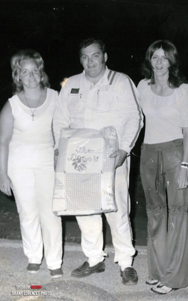 Black and white abstract pattern with concentric circles and wave shapes.