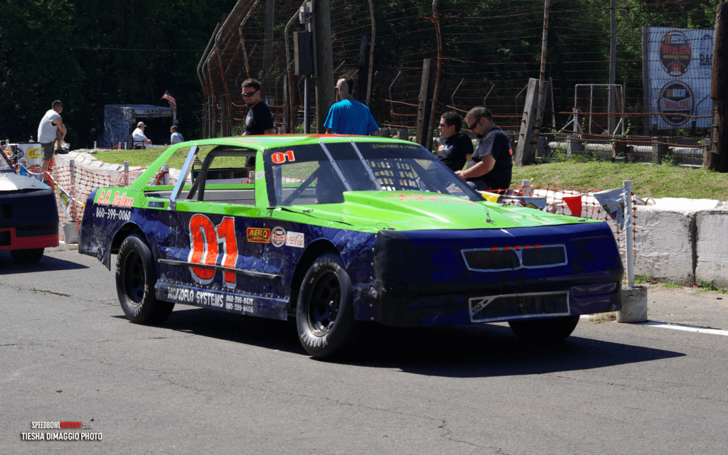 Blue and green race car number 91 on the track.
